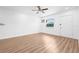 Bright and airy bedroom featuring fresh wood floors and white walls, complemented by a ceiling fan and a window at 5326 22Nd N Ave, St Petersburg, FL 33710