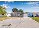 Charming single-story home with a well-maintained lawn and an attached garage under a bright blue sky at 5326 22Nd N Ave, St Petersburg, FL 33710