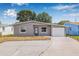 Cozy one-story home featuring a well-maintained lawn and convenient attached garage on a sunny day at 5326 22Nd N Ave, St Petersburg, FL 33710