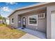 Close-up of a gray home featuring a well-kept lawn and an inviting front entrance with a charming mailbox at 5326 22Nd N Ave, St Petersburg, FL 33710