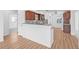 Modern kitchen features light wood floors, a breakfast bar, dark wood cabinets, and stainless steel appliances at 5326 22Nd N Ave, St Petersburg, FL 33710