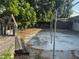 View of the backyard featuring concrete slab, metal frame structure and wooden deck at 5600 9Th N Ave, St Petersburg, FL 33710
