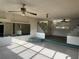 View of living room featuring multiple ceiling fans and glass block partitions at 5600 9Th N Ave, St Petersburg, FL 33710