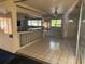 Spacious living room featuring tile flooring, a breakfast bar and plenty of natural light at 5600 9Th N Ave, St Petersburg, FL 33710