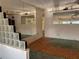 Open-concept living room with glass block partitions and ceiling fans at 5600 9Th N Ave, St Petersburg, FL 33710