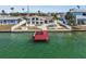 Aerial view of house, dock, and waterfront backyard with pool at 600 115Th Ave, Treasure Island, FL 33706