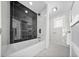 Modern bathroom featuring marble tile, a soaking tub, and a separate toilet room at 600 115Th Ave, Treasure Island, FL 33706