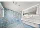 Beautiful bathroom with luxury walk-in shower, designer tiling, and dual sink vanity at 600 115Th Ave, Treasure Island, FL 33706