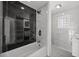 Modern bathroom features a tub, shower, and elegant marble tile accents and fixtures at 600 115Th Ave, Treasure Island, FL 33706
