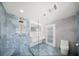 Contemporary bathroom featuring blue marble-style tile, double vanity, and glass-enclosed shower at 600 115Th Ave, Treasure Island, FL 33706