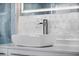 Stylish bathroom sink featuring modern faucet, geometric tiled backsplash, and clean lines at 600 115Th Ave, Treasure Island, FL 33706