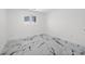 Bright bedroom with white walls, modern marble floors, and a view from the window at 600 115Th Ave, Treasure Island, FL 33706