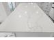 Close-up on a white kitchen island with unique, intricate marble-patterned countertop at 600 115Th Ave, Treasure Island, FL 33706