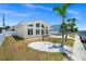 Home exterior featuring manicured yard, updated windows, and waterfront view at 600 115Th Ave, Treasure Island, FL 33706