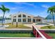Backyard view featuring modern home with pool, patio and dock, perfect for outdoor living at 600 115Th Ave, Treasure Island, FL 33706