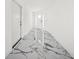 Hallway featuring sleek marble floors and pristine white walls at 600 115Th Ave, Treasure Island, FL 33706