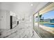 Well-lit kitchen with white cabinets, an island, stainless steel appliances, and access to the outdoor patio at 600 115Th Ave, Treasure Island, FL 33706