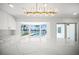 Bright kitchen features a large island with white marble countertop, a bay window, and modern light fixtures at 600 115Th Ave, Treasure Island, FL 33706