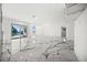 Bright living area with marble floors, modern lighting, and water views at 600 115Th Ave, Treasure Island, FL 33706