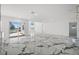The open-concept living room boasts marble floors and easy access to outdoor spaces and water views at 600 115Th Ave, Treasure Island, FL 33706