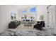 Bright and airy living room with large windows offering water views, modern marble floors, and comfortable seating at 600 115Th Ave, Treasure Island, FL 33706