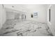 Spacious living room with marble floors, recessed lighting, and modern design at 600 115Th Ave, Treasure Island, FL 33706