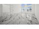 Bright living room with marble floors and water views from the many windows at 600 115Th Ave, Treasure Island, FL 33706