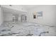 This modern living room has an open floor plan, marble floors and seamless transitions to other spaces at 600 115Th Ave, Treasure Island, FL 33706
