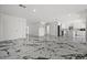 Spacious living room with marble floors and open concept design flowing into the kitchen and dining area at 600 115Th Ave, Treasure Island, FL 33706