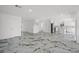 Spacious open-concept living area features white marble floors and modern finishes throughout the home at 600 115Th Ave, Treasure Island, FL 33706