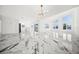 Bright, open living room with marble floors, chandelier and abundant natural light at 600 115Th Ave, Treasure Island, FL 33706