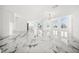 Expansive living room featuring marble floors, modern lighting, and open floor plan at 600 115Th Ave, Treasure Island, FL 33706