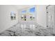 Bright living room featuring marble floors, high ceilings and large windows with beautiful water views at 600 115Th Ave, Treasure Island, FL 33706