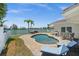 Beautiful pool area with waterfront view, outdoor seating, grill, and lounge chairs for ultimate relaxation at 600 115Th Ave, Treasure Island, FL 33706