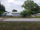 View of the home showing the white lattice skirting and the side of the property at 6095 108Th N Ave, Pinellas Park, FL 33782