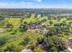 Expansive aerial view showcases a golf course community with lush green fairways, serene ponds, and beautiful landscaping at 629 Fort Duquesna Dr, Sun City Center, FL 33573