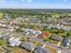 Aerial view of a neighborhood with mature trees, and a golf course in the distance at 629 Fort Duquesna Dr, Sun City Center, FL 33573