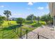 Spacious backyard with lush lawn, mature trees, and secure black metal fencing at 629 Fort Duquesna Dr, Sun City Center, FL 33573