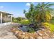 Tranquil backyard featuring a rock-lined pond with small waterfall and palm trees at 629 Fort Duquesna Dr, Sun City Center, FL 33573