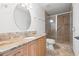 Beautiful bathroom featuring granite counters, walk-in shower, and modern fixtures, blending elegance with functionality at 629 Fort Duquesna Dr, Sun City Center, FL 33573