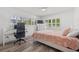 Inviting bedroom features a comfortable bed, bright natural light, and dedicated workspace providing comfort and productivity at 629 Fort Duquesna Dr, Sun City Center, FL 33573
