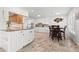 Bright kitchen featuring white cabinets, modern appliances, and a dining area at 629 Fort Duquesna Dr, Sun City Center, FL 33573