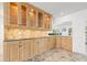 Gourmet kitchen with wood cabinets, granite countertops, and modern appliances at 629 Fort Duquesna Dr, Sun City Center, FL 33573