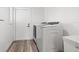 Bright laundry room featuring a modern washer, dryer, and light wood-look flooring at 629 Fort Duquesna Dr, Sun City Center, FL 33573