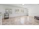 Bright living room featuring large windows, neutral color palette, and stylish tile flooring, creating an inviting atmosphere at 629 Fort Duquesna Dr, Sun City Center, FL 33573