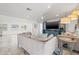 Comfortable living room featuring neutral colors, large TV, and access to kitchen and other rooms at 629 Fort Duquesna Dr, Sun City Center, FL 33573