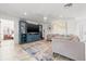 Spacious living room with a fan, TV, shelving, and view into an adjacent room at 629 Fort Duquesna Dr, Sun City Center, FL 33573