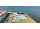 Aerial view of community pool near the water and building at 7 Elgin Pl # 202, Dunedin, FL 34698