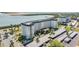 Beautiful condominium complex showcasing lush landscaping, covered parking, and a grand entrance at 7 Elgin Pl # 202, Dunedin, FL 34698