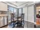 Efficient kitchen area with stainless steel appliances, dark tile floors, and a practical dining space at 7 Elgin Pl # 202, Dunedin, FL 34698